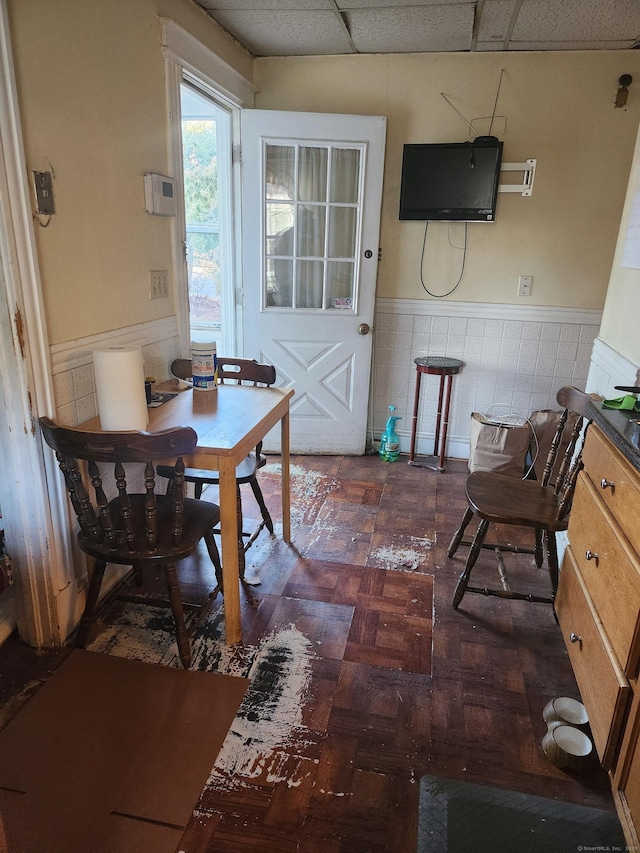 dining space with a paneled ceiling