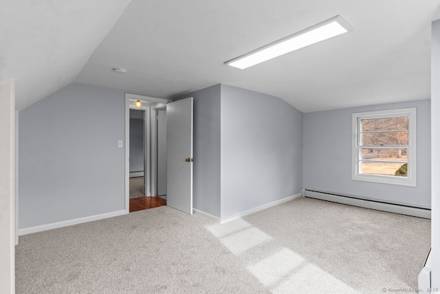 bonus room featuring vaulted ceiling, carpet floors, and a baseboard heating unit