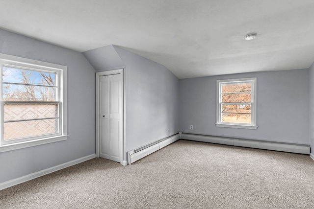 additional living space featuring plenty of natural light, light colored carpet, and lofted ceiling