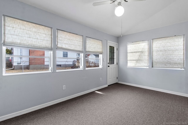 carpeted empty room featuring ceiling fan and lofted ceiling