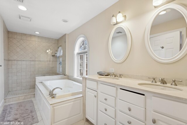 bathroom featuring vanity, independent shower and bath, and tile patterned flooring