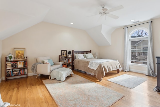 bedroom with hardwood / wood-style flooring, vaulted ceiling, and ceiling fan