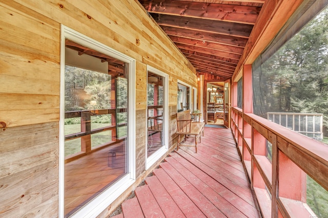 unfurnished sunroom with vaulted ceiling