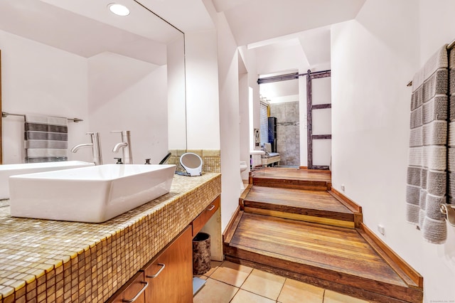 bathroom featuring tile patterned flooring, vanity, and toilet