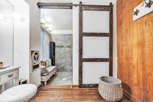 bathroom featuring tile patterned flooring, vanity, and tile walls