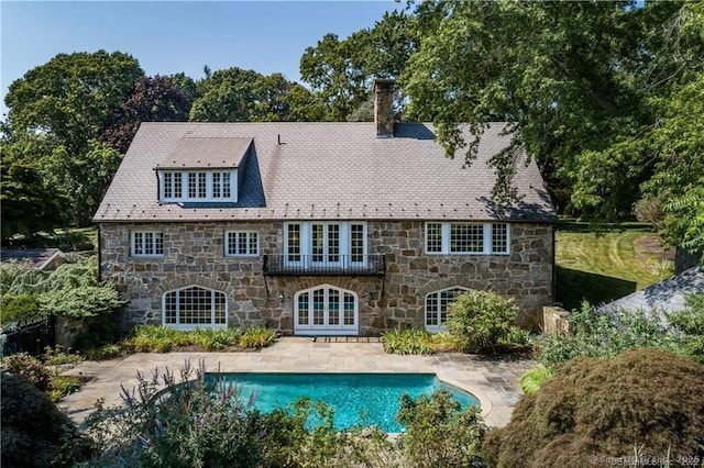 back of property with a patio area and french doors