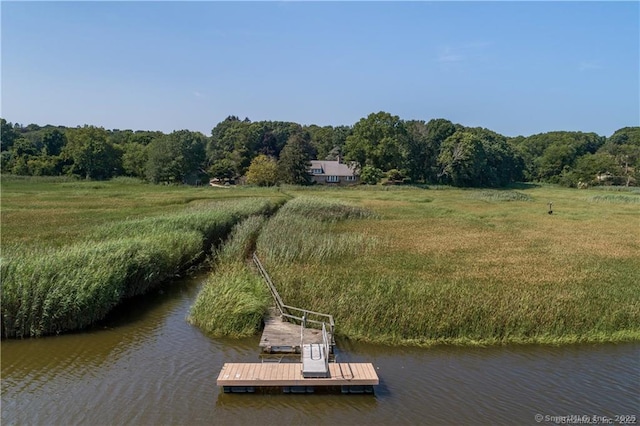 exterior space with a rural view and a water view