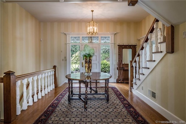 dining area with wood-type flooring and a chandelier