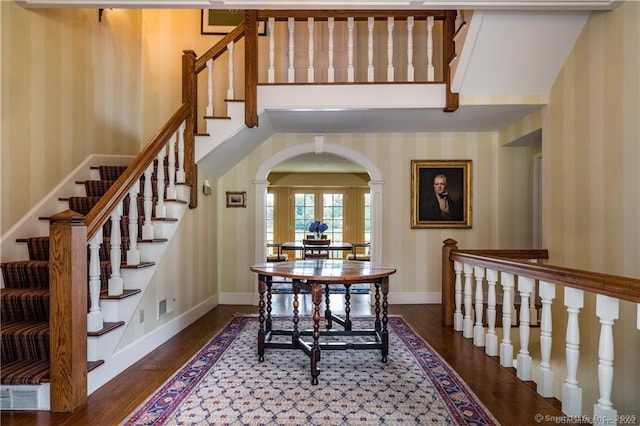 stairway with hardwood / wood-style flooring and french doors