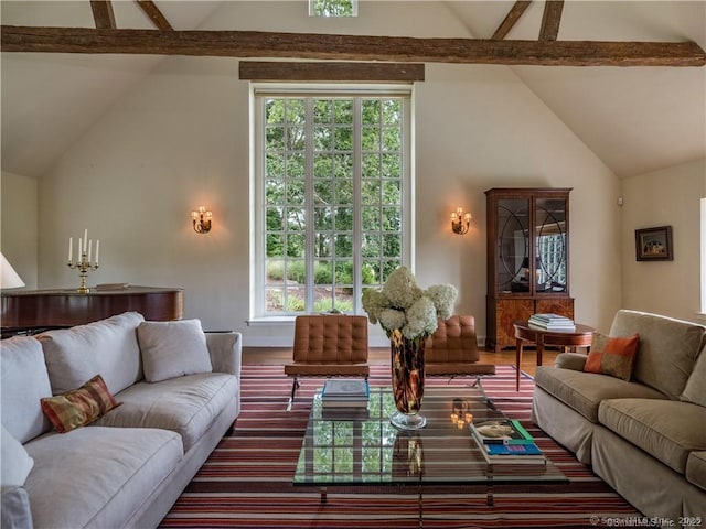 living room with vaulted ceiling with beams and dark wood-type flooring