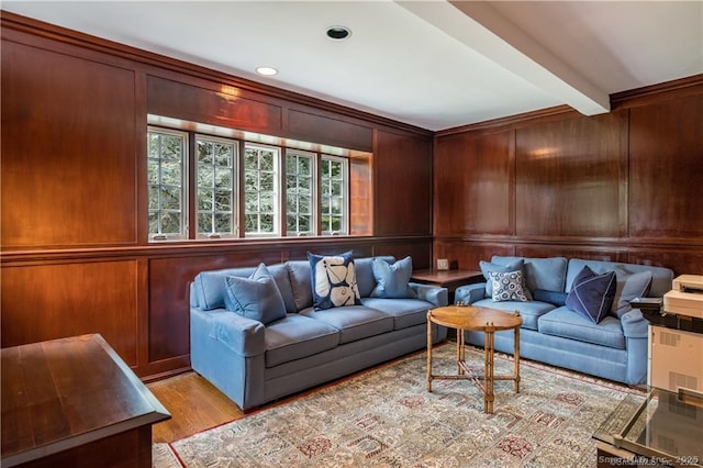 interior space featuring wooden walls, beamed ceiling, and light hardwood / wood-style floors