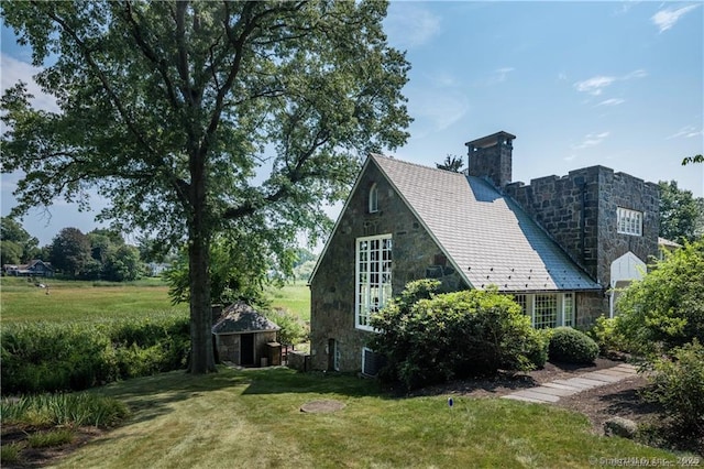 view of side of home featuring a yard