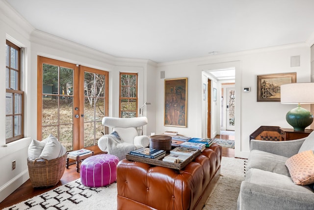 living room featuring french doors, hardwood / wood-style floors, and crown molding