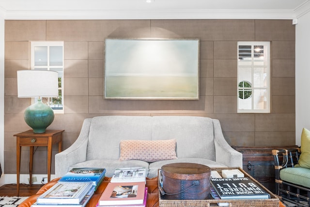 sitting room with ornamental molding and hardwood / wood-style floors