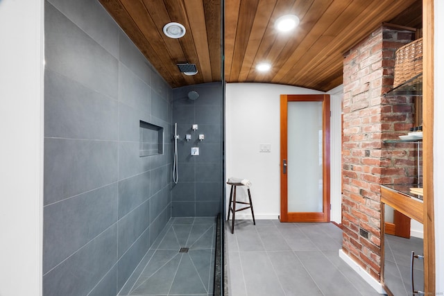 bathroom with wood ceiling and a tile shower