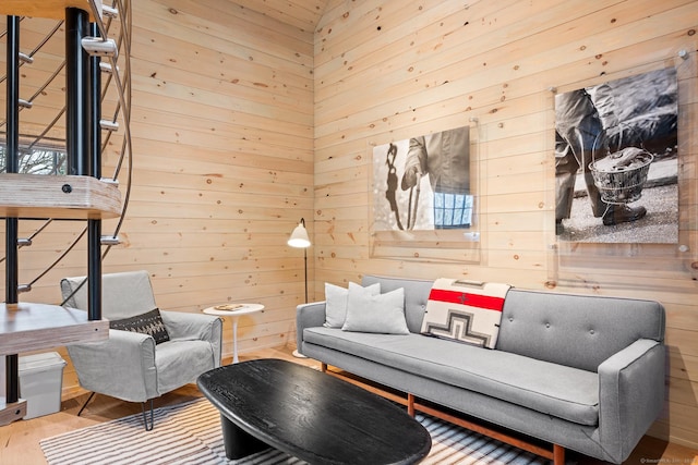 living room featuring wood walls and wood-type flooring