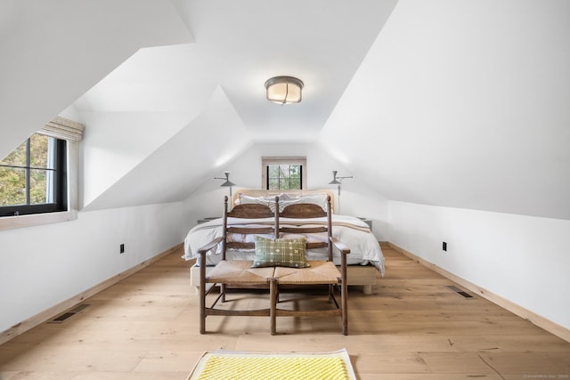 bedroom featuring vaulted ceiling and light hardwood / wood-style flooring