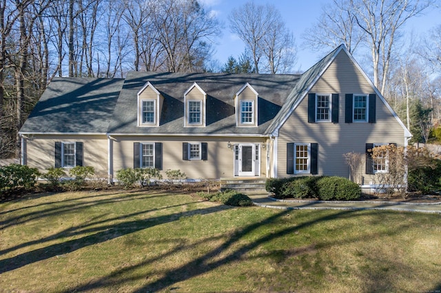 cape cod home with a front lawn