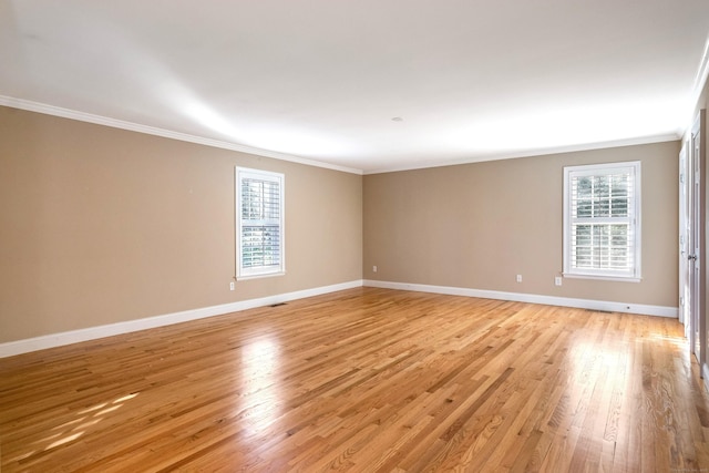 unfurnished room featuring light wood-type flooring and crown molding