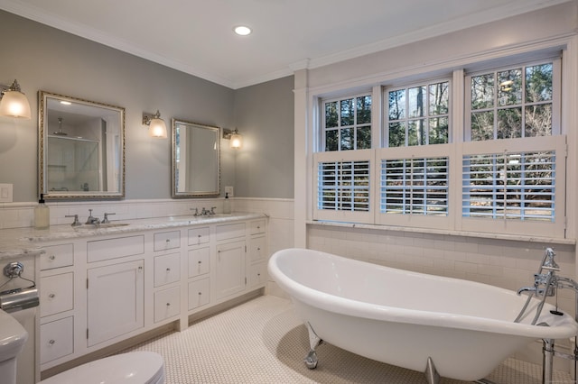 bathroom featuring tile patterned flooring, tile walls, ornamental molding, independent shower and bath, and vanity