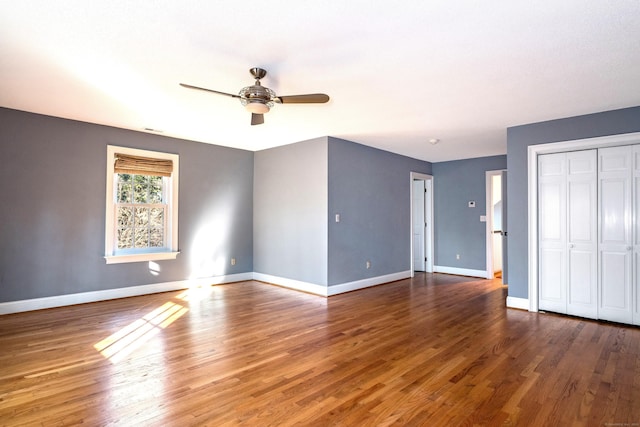 unfurnished bedroom featuring ceiling fan and dark hardwood / wood-style flooring