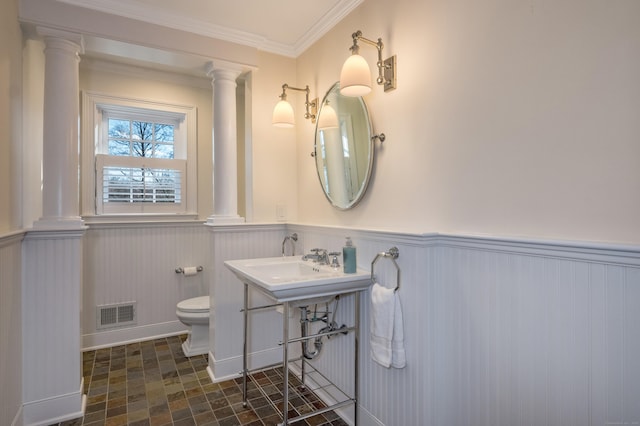 bathroom featuring toilet and ornamental molding