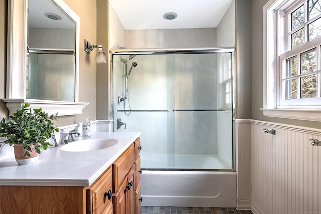 bathroom featuring vanity and shower / bath combination with glass door