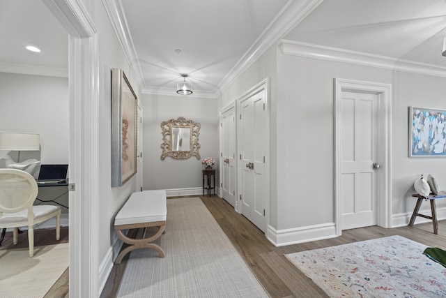 hallway featuring hardwood / wood-style floors and ornamental molding