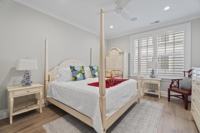 bedroom featuring dark hardwood / wood-style floors, ceiling fan, and ornamental molding