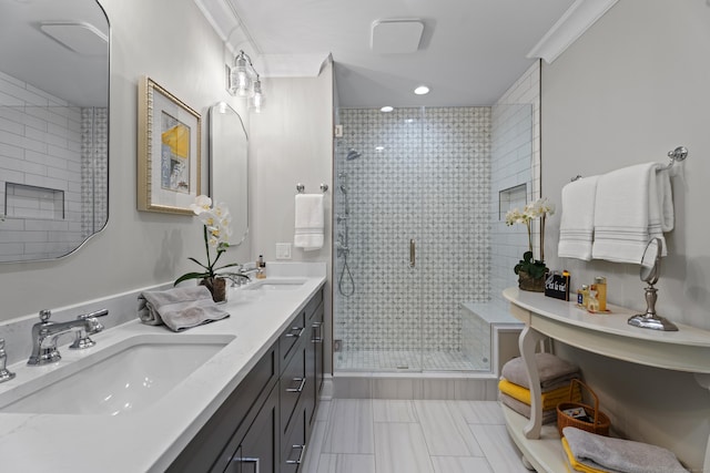 bathroom featuring vanity, a shower with shower door, and ornamental molding