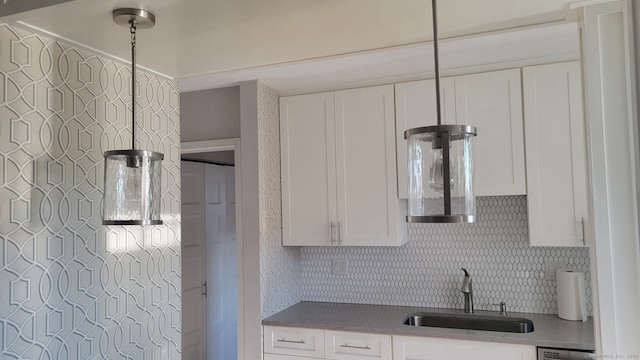 kitchen with sink, decorative backsplash, and white cabinets