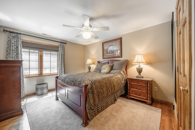 bedroom featuring a closet, light hardwood / wood-style flooring, and ceiling fan