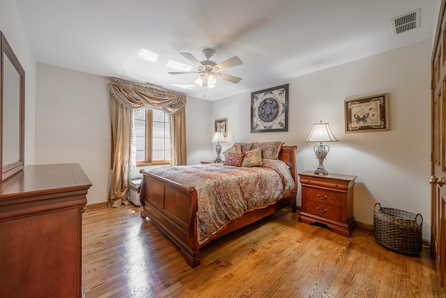 bedroom with ceiling fan and light hardwood / wood-style flooring