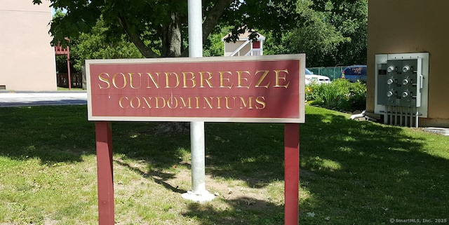 community sign featuring a lawn