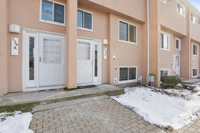 view of snow covered property entrance