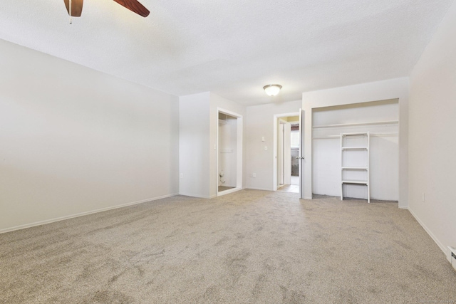 unfurnished bedroom featuring ceiling fan, carpet flooring, a closet, and a textured ceiling