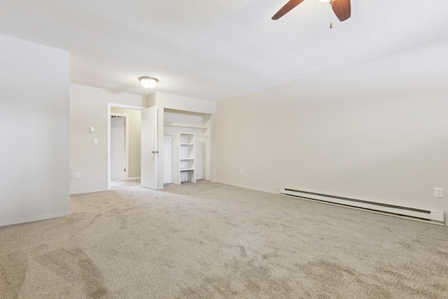 unfurnished living room featuring baseboard heating, ceiling fan, light carpet, and a textured ceiling