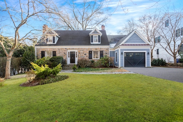 cape cod-style house featuring a front yard and a garage