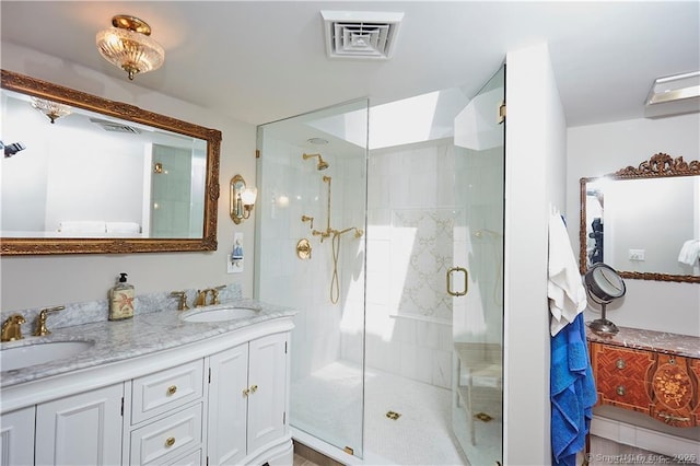 bathroom with a shower with shower door and vanity