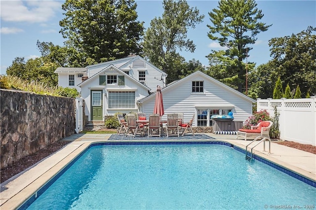 view of swimming pool featuring a patio area and an outdoor structure