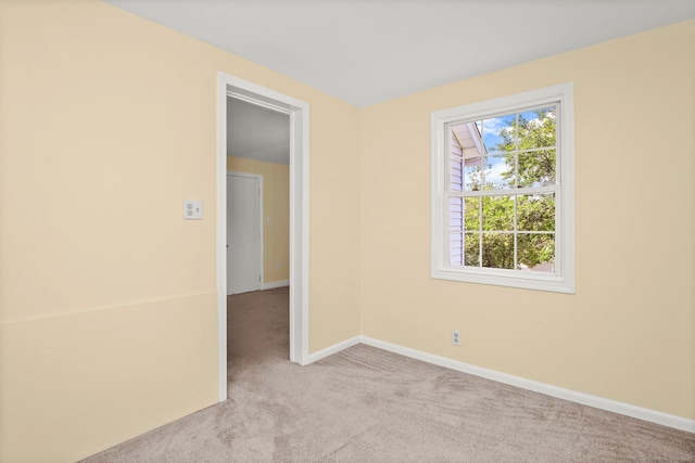 empty room featuring light carpet