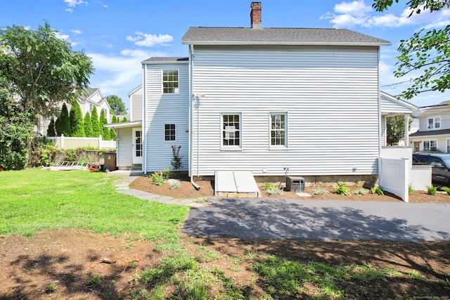 back of house with a lawn