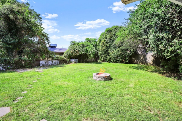 view of yard with an outdoor fire pit