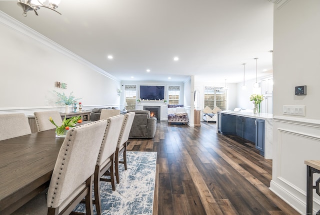 dining space featuring crown molding, dark hardwood / wood-style floors, and an inviting chandelier