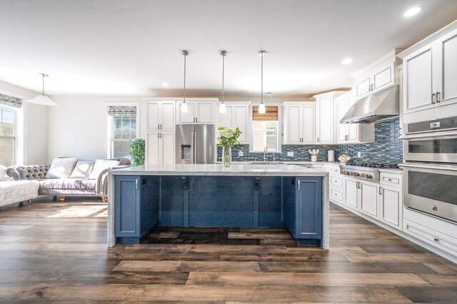 kitchen with a kitchen island, decorative light fixtures, blue cabinets, white cabinets, and stainless steel appliances