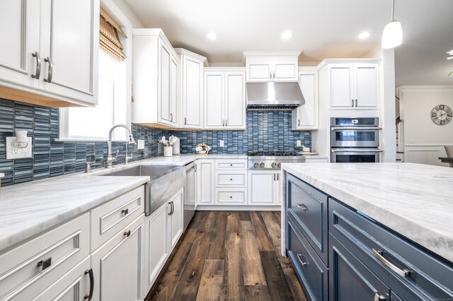 kitchen featuring pendant lighting, white cabinetry, stainless steel appliances, and sink