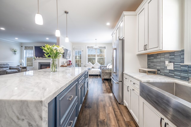 kitchen with dark wood-style floors, open floor plan, high end refrigerator, and white cabinetry