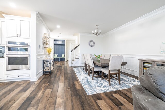 dining space with ornamental molding, dark wood-type flooring, and a chandelier