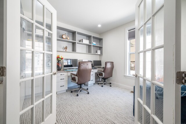 carpeted office with french doors