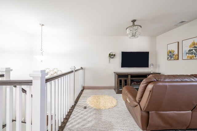 living area featuring visible vents, baseboards, and an inviting chandelier